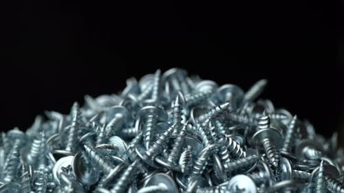 Close Up of Silver Screws on Dark Background