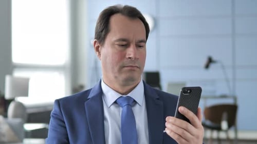 Man in Suit Celebrates Good News on Phone