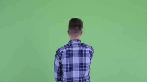 Rear View of Young Hipster Man Pointing Finger