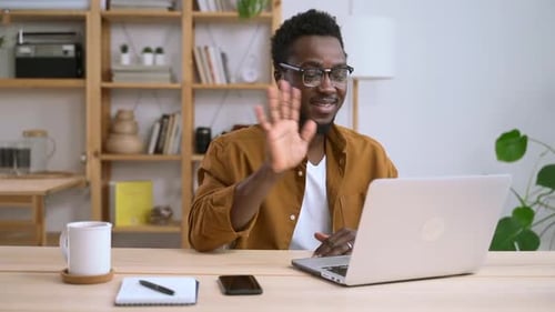 Young Man Video Calling From Home Office