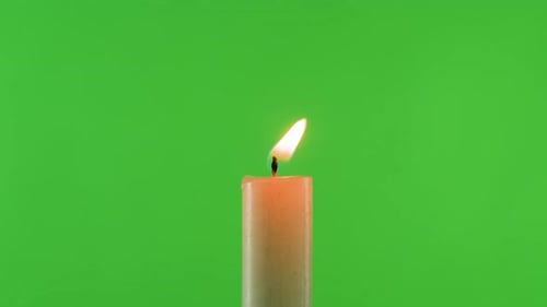 Burning Wax Candle on Green Chroma Key Background