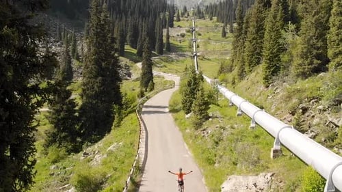Man Ride Bicycle on the Mountain Road Top View