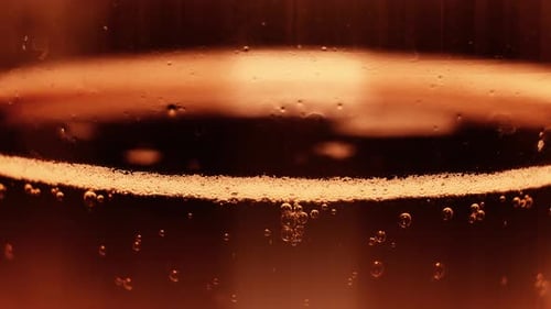 Amber liquid with bubbles in a close up shot