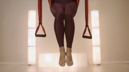 Sportswoman Practicing Yoga in Hammock at Studio. Girl Exercising Fly Yoga