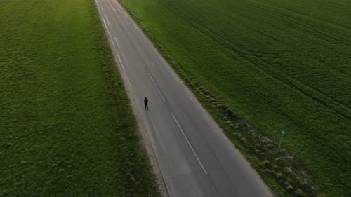 A Young Woman Running Down the Road