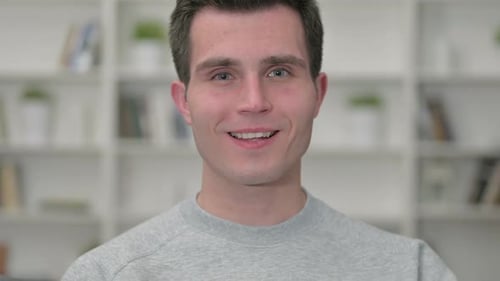 Young Adult Giving Thumbs Up Gesture Close Up