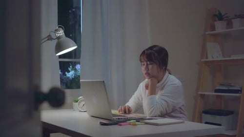 Young Adult Working on Laptop at Desk
