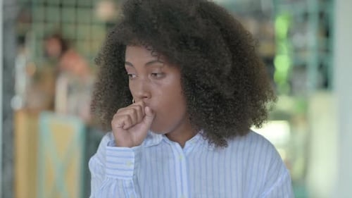 Young Adult Woman Coughing Close Up Indoors
