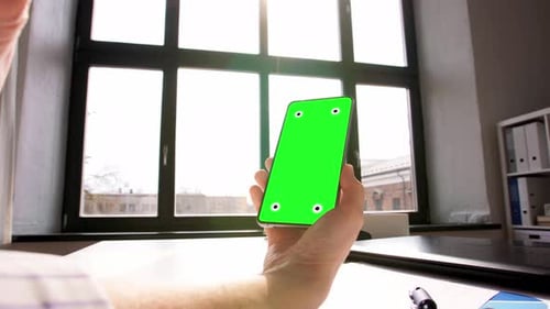 Hand with Green Screen on Phone at Home Office