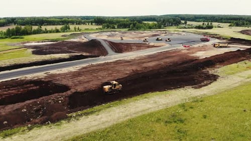 Aerial View of Big Trucks and Cars That are Building Roads for Testing Ground for Cars