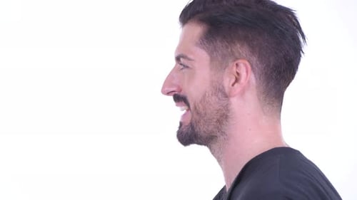 Closeup Profile View of Happy Young Handsome Bearded Man Talking