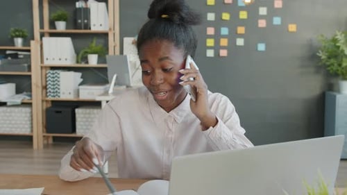 Slow Motion of Cheerful Afro-American Office Worker Speaking on Mobile Phone and Smiling