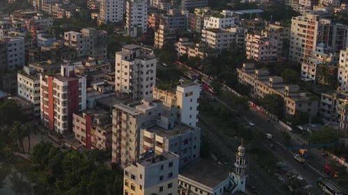 Aerial : city view with highway and high rise buildings - zoom out establishing shot