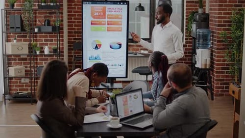 Business Team Analyzes Data During Modern Office Meeting