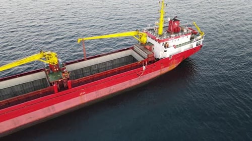 Cargo Ship Sailing on Ocean at Sunset Aerial View