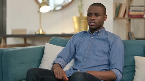 Adult Man Coughing on Sofa at Home