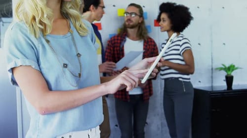 Diverse Team Collaborating in Modern Workplace with Technology