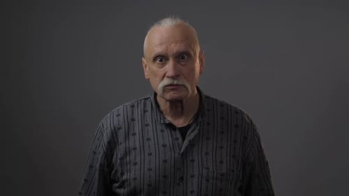 Senior Man with Gray Hair Gesturing with Fist