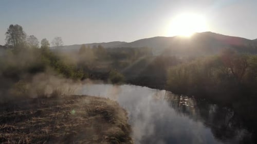 Fog Morning Over the Plain and River Floodplain of the Meadow Near a Rural Village with a House