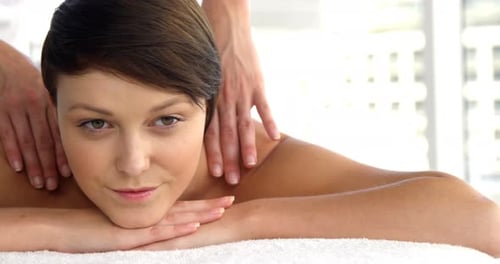 Front view of woman therapist massaging the shoulders of her patient