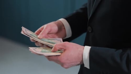 Businessman Counting Dollar Banknotes Close Up