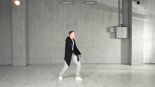 Trendy Caucasian Boy Performing Dance Moves in Studio