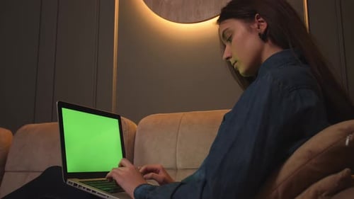 Focused Woman Typing on Laptop Green Screen Chromakey Browsing Internet Study or Work Sitting on