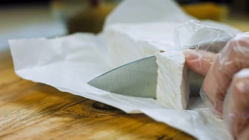 The Chef Cuts Brie Cheese