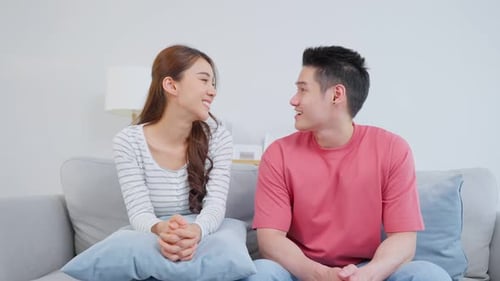 Happy Couple Smiling Together on a Couch