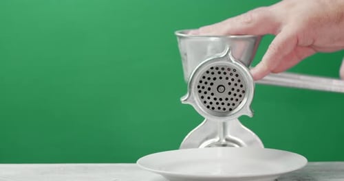 Men's Hands Make Raw Minced Meat on a Meat Grinder