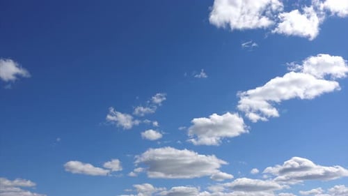 Blue Sky with Fluffy White Clouds Moving Slowly