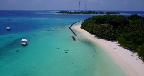Wide angle birds eye island view of a white paradise beach and aqua blue ocean background in hi res