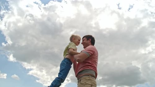 Loving Father Tossing Little Boy