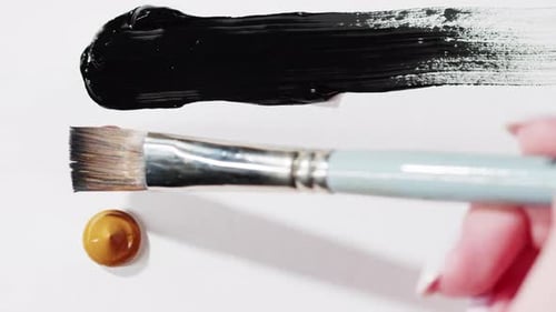 Paintbrush Spreads Red Paint on White Background
