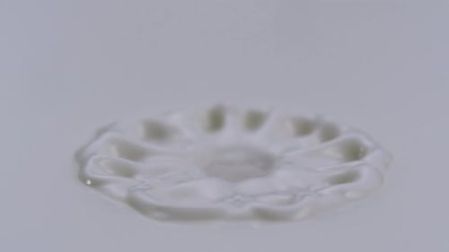 Slow-motion milk dropping and splashing