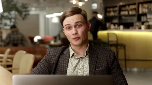 Male office worker communicates in zoom with work colleagues or clients