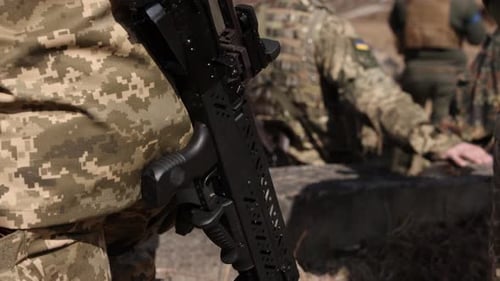 Military Soldiers in Camouflage Gear Standing with Weapons