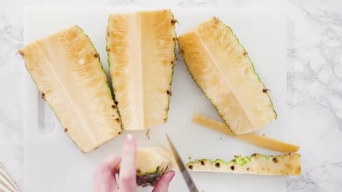 Cutting Pineapple on Cutting Board with Knife