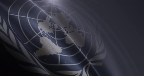 United Nations Flag Waving Gently with Light Flare