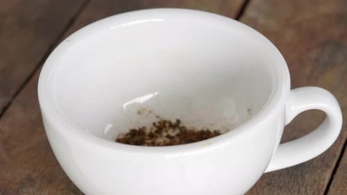 Coffee and Sugar Added to Cup on Table