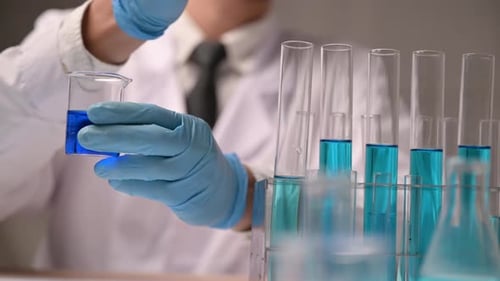 Scientist Using Dropper Transferring Blue Liquid