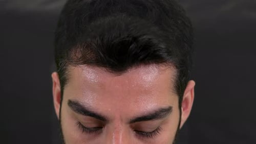 Young Adult Adjusts Face Mask in Close Up