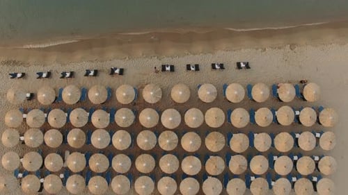 Flying Over Empty Sunbeds at Seaside in the Morning