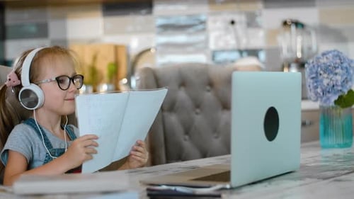 Young Girl Learning Online at Home with Laptop