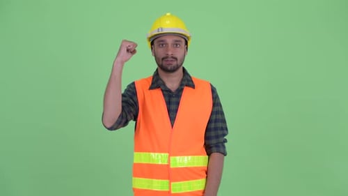 Construction Worker Raising Fist in Celebration on Green Screen