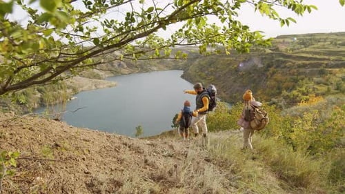 Family Hiking in Rural Landscape with Lake
