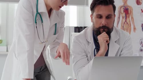 Handheld view of doctors discussing some medical records, Shot with RED helium camera