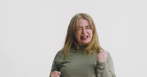 Joyful Mature Woman with Braces Jumps Celebrating News