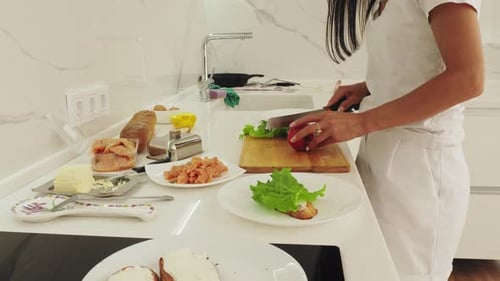 Young Adult Preparing Appetizers in Bright Kitchen