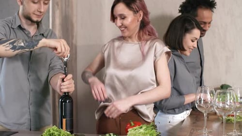 Friends Preparing Food and Opening Wine in Kitchen